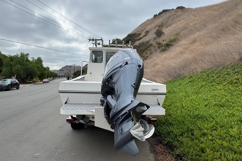 Slide: The Image of 2026 Defiance Admiral 220 EX boat with Yamaha outboard motor on roadside. - 8