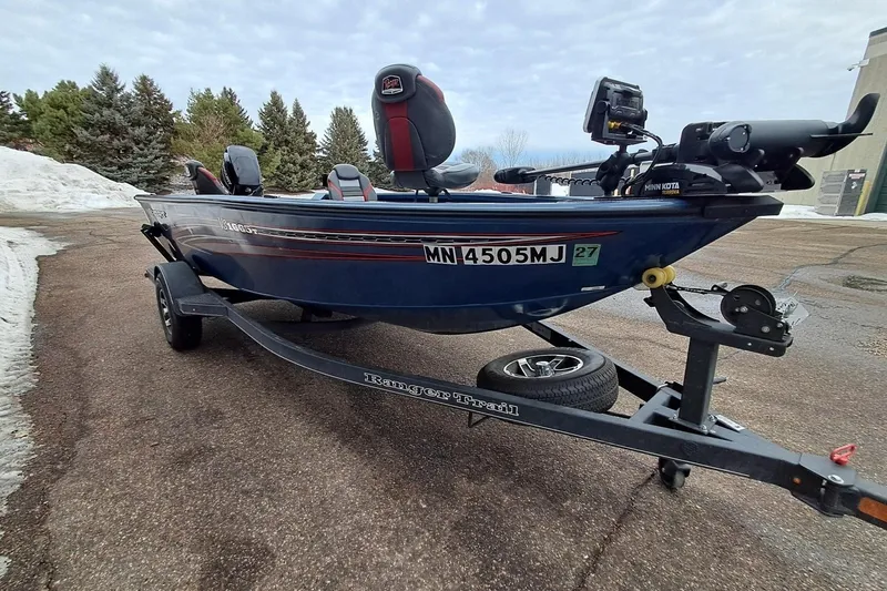 Slide: The Image of 2022 Ranger VS1665T boat on trailer, parked on snowy road with trees in background. - 3