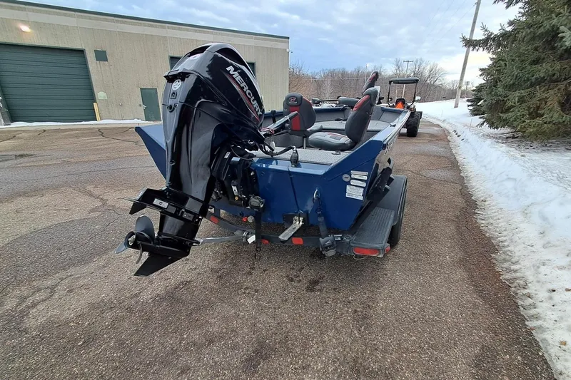 Slide: The Image of 2022 Ranger VS1665T boat with Mercury outboard motor on a snowy driveway. - 4