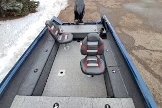 Slide: The Image of 2022 Ranger VS1665T boat interior with two seats, gray and red accents, and carpeted flooring. - 9
