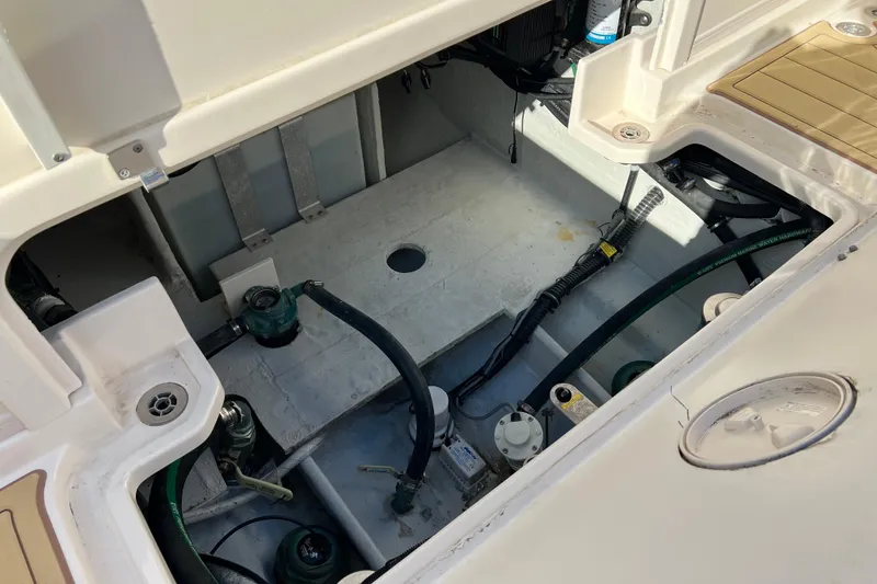 Slide: The Image of 2021 Grady-White Marlin 300 boat interior showing engine compartment and wiring. - 10