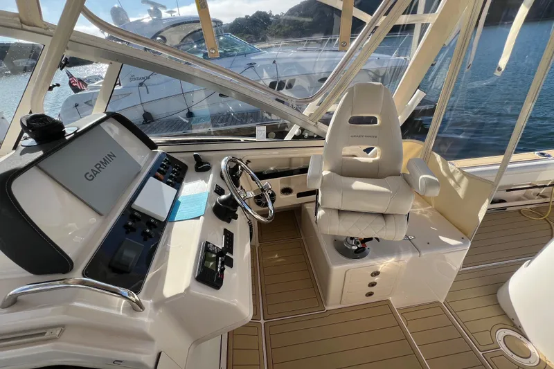 Slide: The Image of 2021 Grady-White Marlin 300 helm with Garmin navigation, luxurious seating, and modern controls. - 12