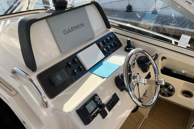 Slide: The Image of 2021 Grady-White Marlin 300 helm with Garmin navigation system and steering wheel. - 13