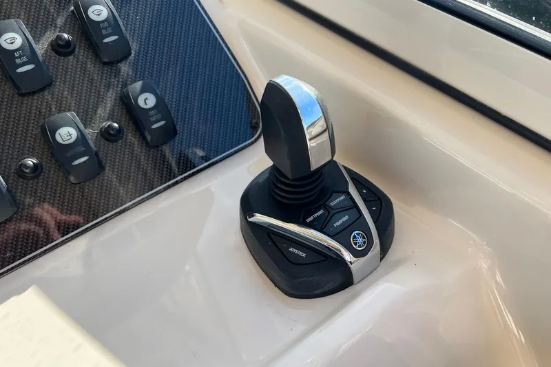 Slide: The Image of Joystick control on 2021 Grady-White Marlin 300 boat dashboard. - 16