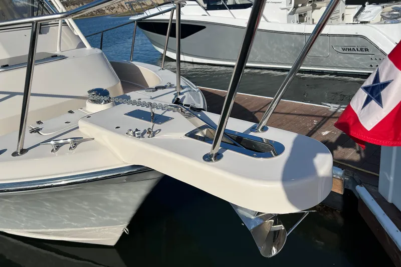 Slide: The Image of 2021 Grady-White Marlin 300 boat bow with anchor and flag at marina. - 21