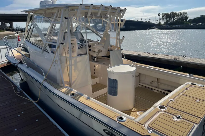 Slide: The Image of 2021 Grady-White Marlin 300 boat docked by the water on a sunny day. - 3