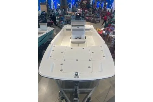 Slide: The Image of 2025 Mako Pro Skiff 19 CC boat displayed indoors, showcasing spacious deck and seating. - 72