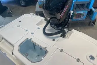 Slide: The Image of 2025 Mako Pro Skiff 19 CC boat with outboard motor in showroom. - 77