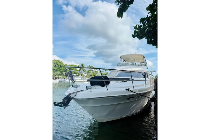 Slide: The Image of 2003 Sea Ray 560 Sedan Bridge yacht docked on a sunny day. - 1