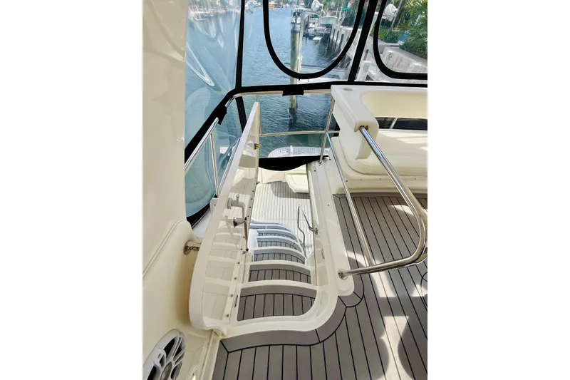 Slide: The Image of 2003 Sea Ray 560 Sedan Bridge yacht interior with stairs and seating area. - 21