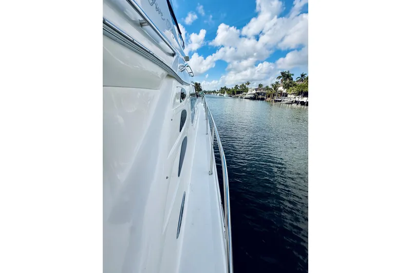 Slide: The Image of Side view of 2003 Sea Ray 560 Sedan Bridge yacht on a sunny day. - 3