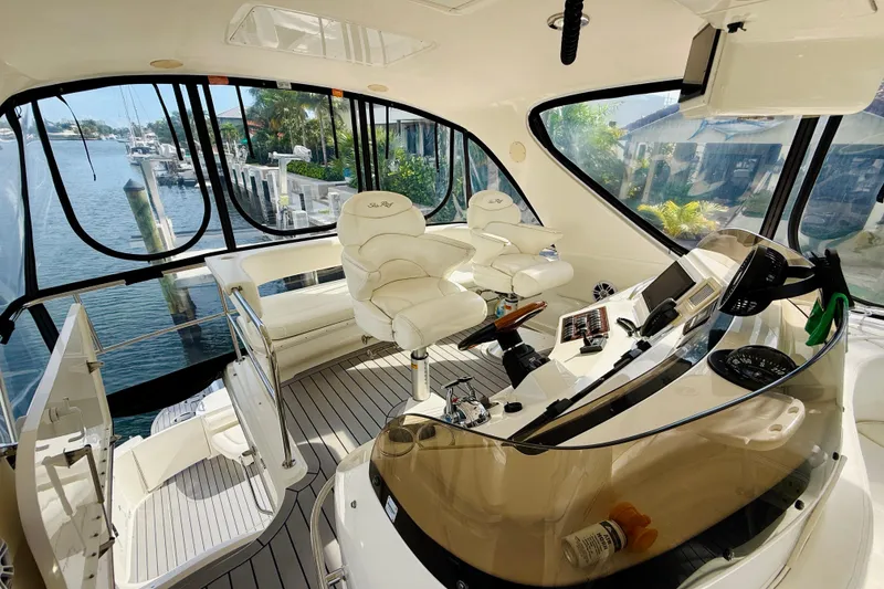 Slide: The Image of Luxurious 2003 Sea Ray 560 Sedan Bridge yacht interior with helm and seating area. - 35