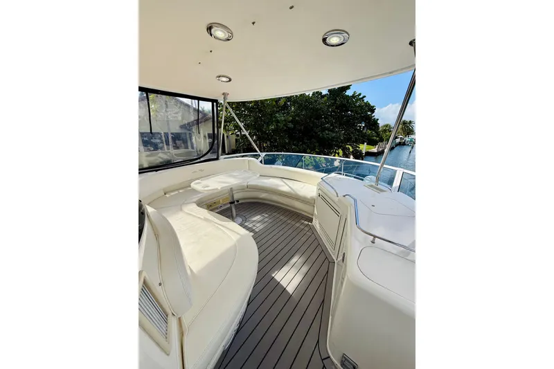 Slide: The Image of 2003 Sea Ray 560 Sedan Bridge yacht interior with seating and scenic water view. - 37