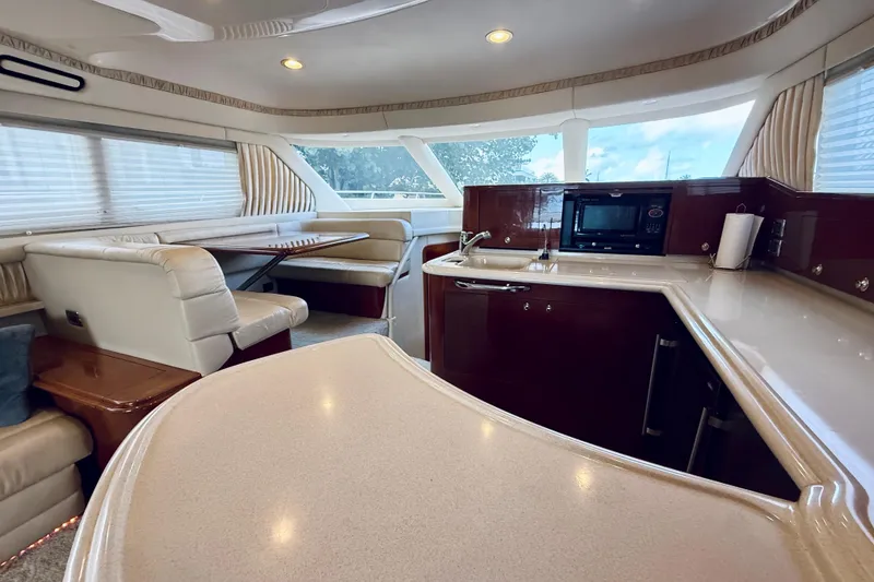 Slide: The Image of Luxurious interior of 2003 Sea Ray 560 Sedan Bridge yacht with kitchen and dining area. - 45