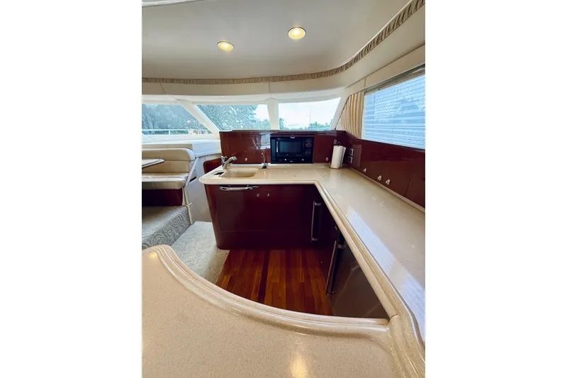 Slide: The Image of Luxurious kitchen interior of 2003 Sea Ray 560 Sedan Bridge yacht with modern amenities. - 46