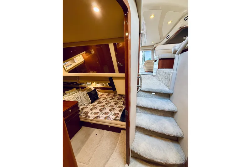 Slide: The Image of Interior of 2003 Sea Ray 560 Sedan Bridge, featuring cozy bedroom and carpeted stairs. - 55