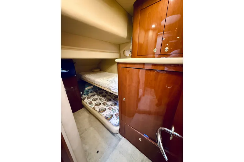 Slide: The Image of 2003 Sea Ray 560 Sedan Bridge cabin with bunk beds and wooden cabinetry. - 57