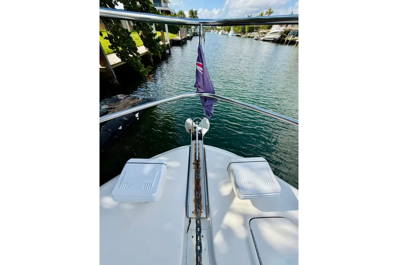 Slide: The Image of Bow view of 2003 Sea Ray 560 Sedan Bridge yacht on a calm waterway. - 6