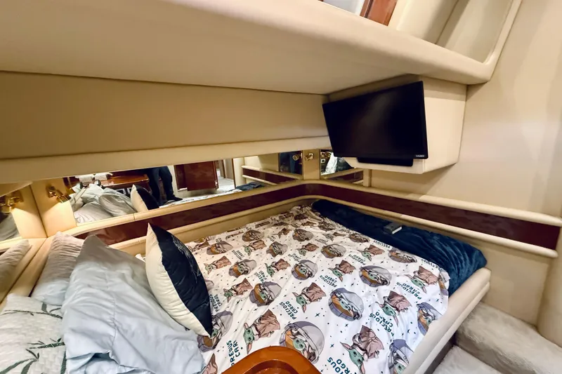 Slide: The Image of Cozy bedroom in 2003 Sea Ray 560 Sedan Bridge with TV and themed bedding. - 61