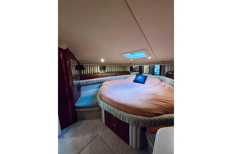 Slide: The Image of Luxurious 2003 Sea Ray 560 Sedan Bridge bedroom with plush bedding and elegant decor. - 64