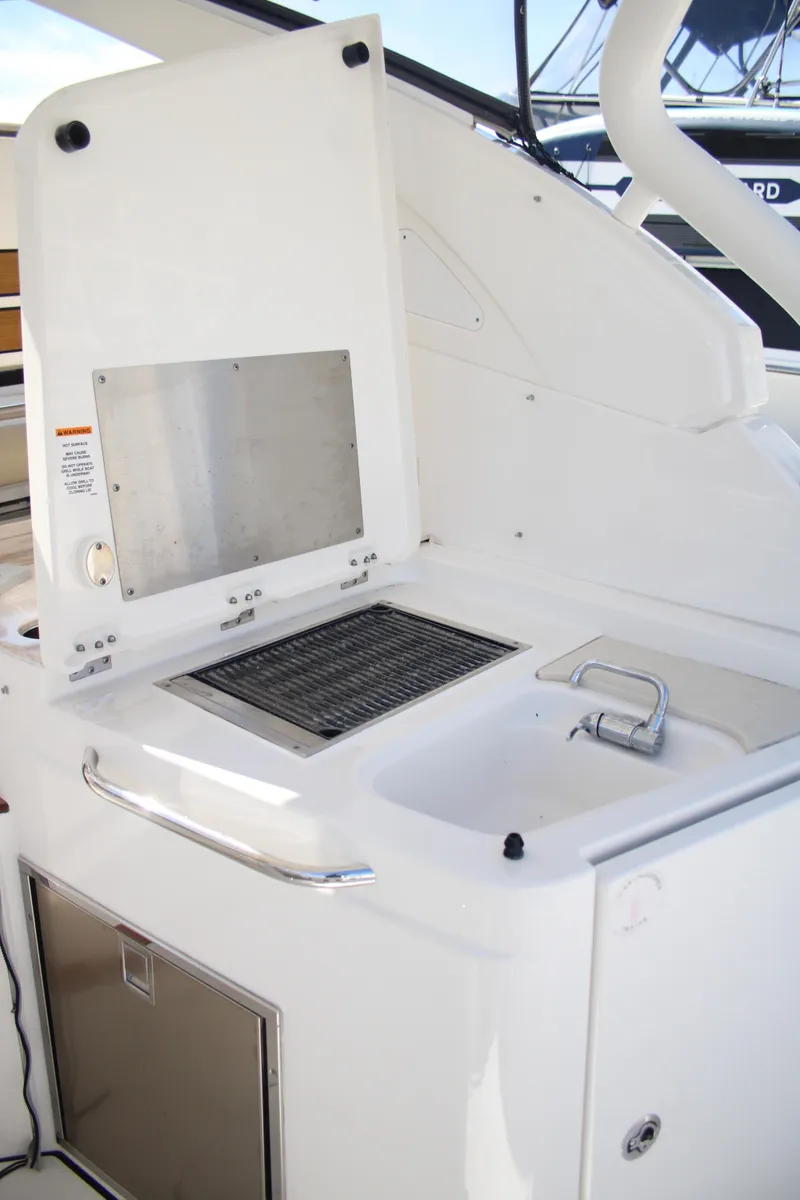 Slide: The Image of 2019 Pursuit DC 365 Dual Console boat with built-in grill and sink. - 22