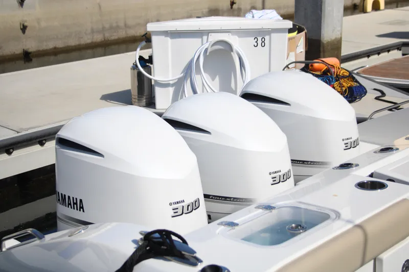 Slide: The Image of Triple Yamaha 300 outboard engines on a 2019 Pursuit DC 365 Dual Console boat. - 36