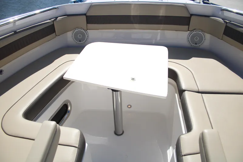 Slide: The Image of 2019 Pursuit DC 365 Dual Console boat interior with table and seating. - 7