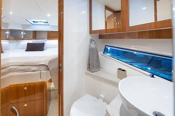 Slide: The Image of Luxurious interior of 2019 Riviera 395 SUV yacht featuring bedroom and bathroom. - 18