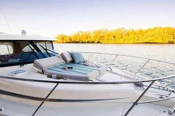 Slide: The Image of 2019 Riviera 395 SUV yacht with sunbathing deck on tranquil water. - 20