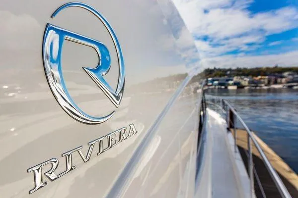 Slide: The Image of 2019 Riviera 395 SUV yacht with logo, docked by the water. - 21