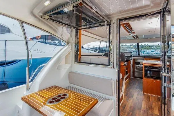 Slide: The Image of Interior of 2019 Riviera 395 SUV yacht with elegant wood finishes and seating area. - 22