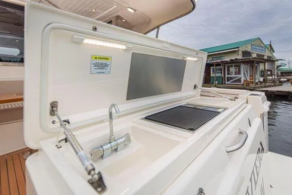 Slide: The Image of 2019 Riviera 395 SUV outdoor kitchen with grill and sink on deck. - 23