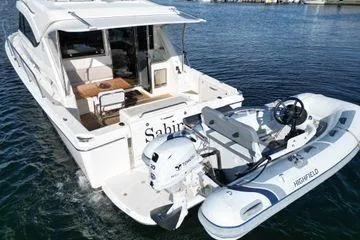 Slide: The Image of 2019 Riviera 395 SUV yacht with attached Highfield tender on water. - 29