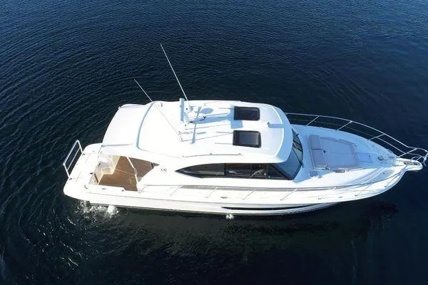 Slide: The Image of 2019 Riviera 395 SUV yacht cruising on calm waters, aerial view. - 31