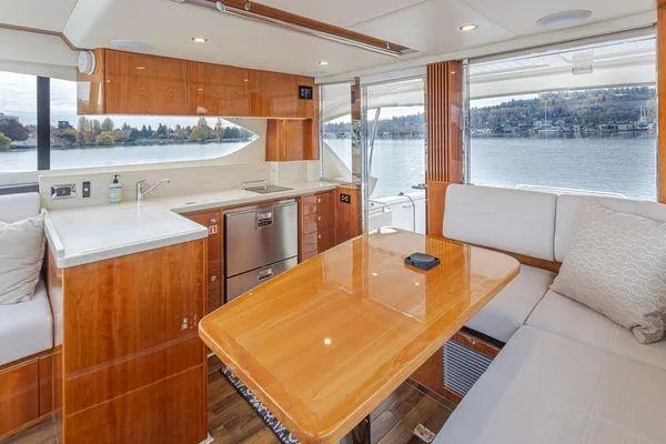 Slide: The Image of Luxurious interior of 2019 Riviera 395 SUV yacht with modern kitchen and scenic water view. - 4