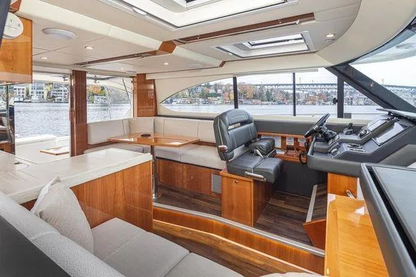 Slide: The Image of Luxurious interior of 2019 Riviera 395 SUV yacht with modern seating and navigation area. - 8