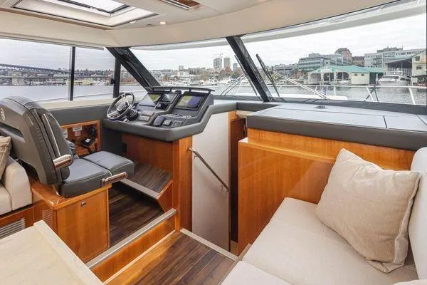 Slide: The Image of Luxurious interior of 2019 Riviera 395 SUV yacht with modern helm and seating area. - 9