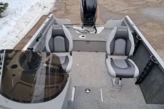 Slide: The Image of 2013 Crestliner 1650 Fish Hawk boat with Mercury outboard motor, parked outdoors. - 4