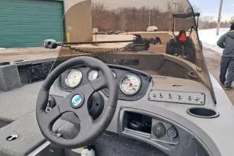 Slide: The Image of 2013 Crestliner 1650 Fish Hawk boat dashboard with steering wheel and gauges. - 7