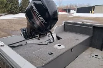 Slide: The Image of 2013 Crestliner 1650 Fish Hawk boat interior with gray seating and Mercury engine. - 8