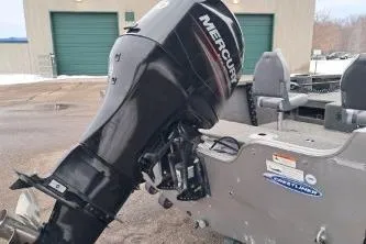 Slide: The Image of 2013 Crestliner 1650 Fish Hawk boat seats, gray upholstery, outdoor setting with trees and snow. - 9