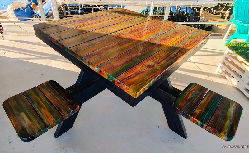 Slide: The Image of Colorful wooden table with built-in seats on a terrace. - 16