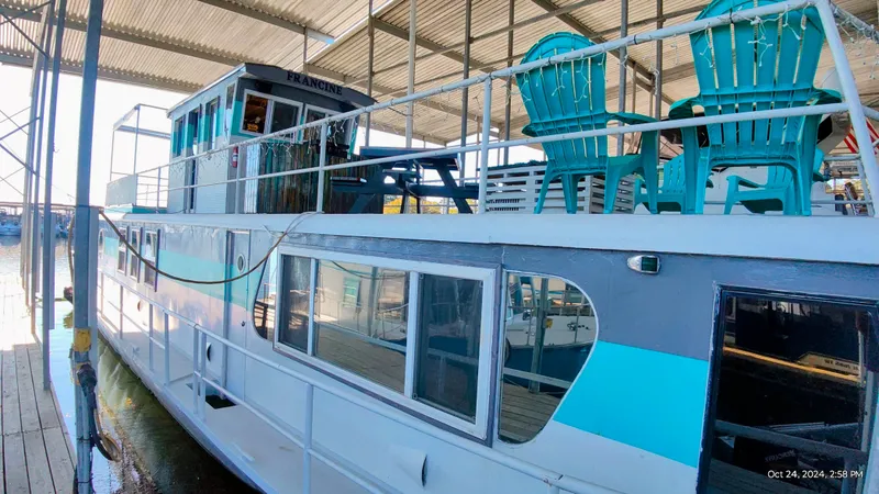 Slide: The Image of 1964 Kelly 62' houseboat with blue chairs on deck. - 2