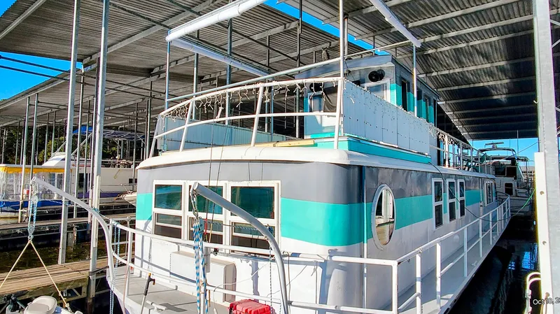 Slide: The Image of 1964 Kelly 62' houseboat docked under a covered marina. - 3