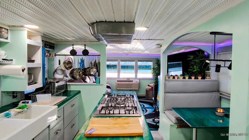 Slide: The Image of Interior of a renovated 1964 Kelly 62' with modern kitchen. - 33