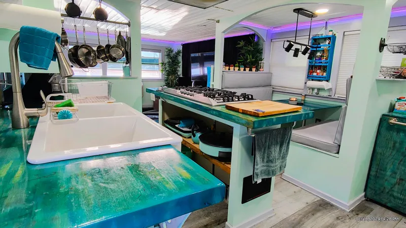 Slide: The Image of Modern kitchen in a 1964 Kelly 62' with turquoise accents. - 36