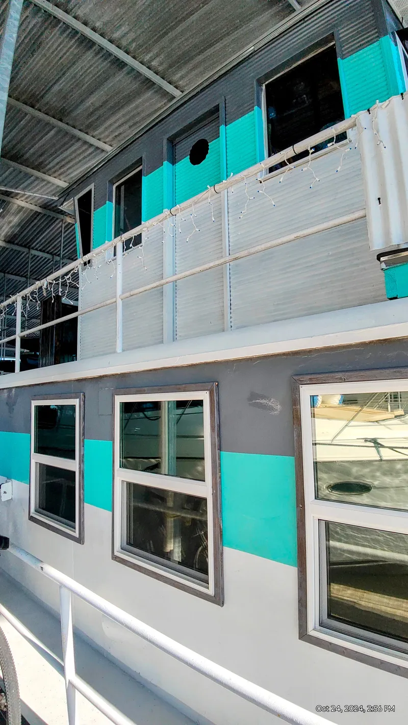 Slide: The Image of 1964 Kelly 62' houseboat with blue and gray exterior. - 6