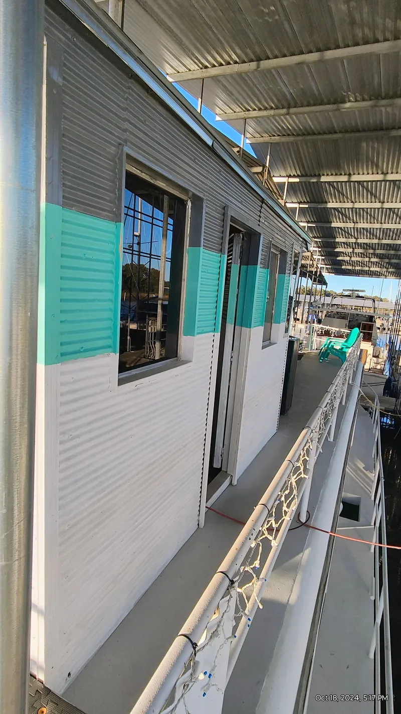 Slide: The Image of 1964 Kelly 62' boat with turquoise and white paint in harbor. - 8