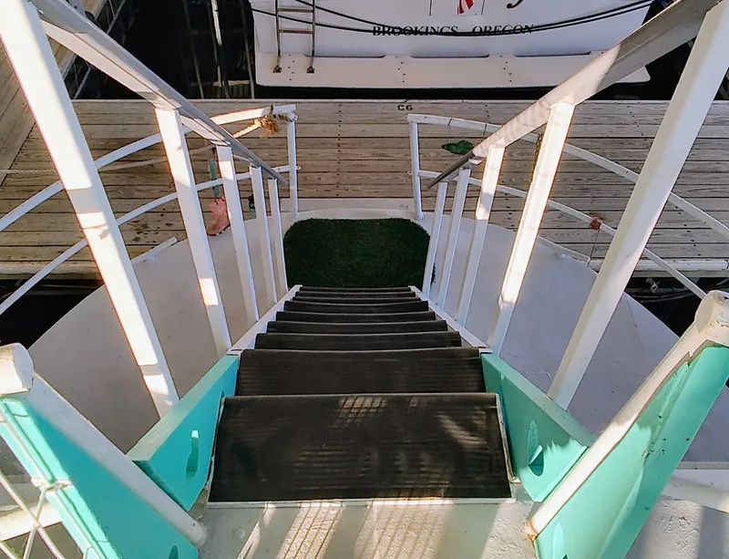 Slide: The Image of Staircase on a 1964 Kelly 62' boat leading to dock. - 9