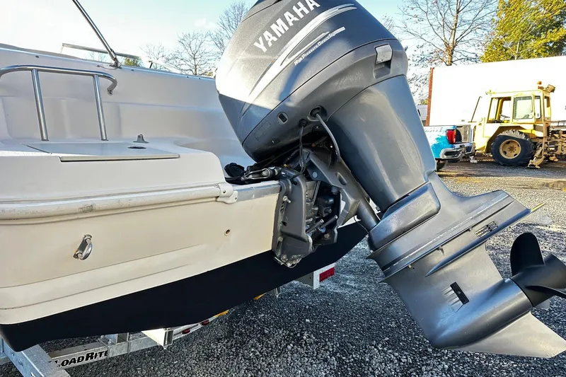 Slide: The Image of 2002 Godfrey Hurricane 237 boat with Yamaha outboard motor on trailer. - 13